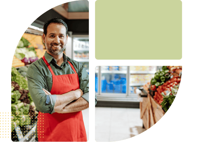 Man with an apron standing in a grocery store